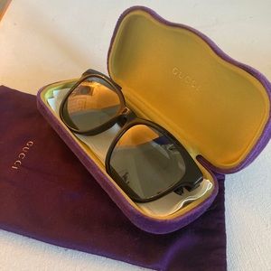 All blacked out Gucci sunglasses.